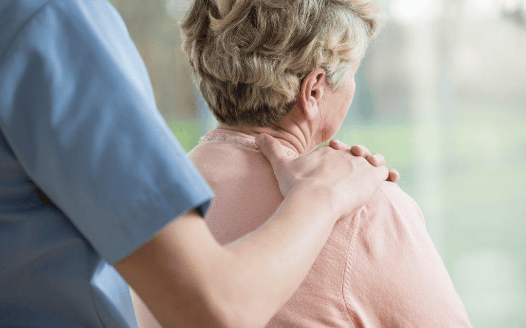 An older resident being supported by a carer